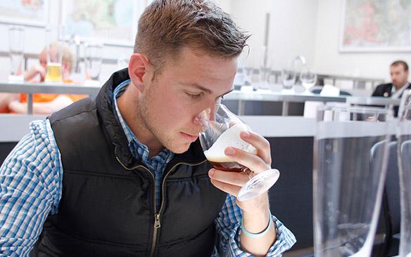 A student samples a beer.